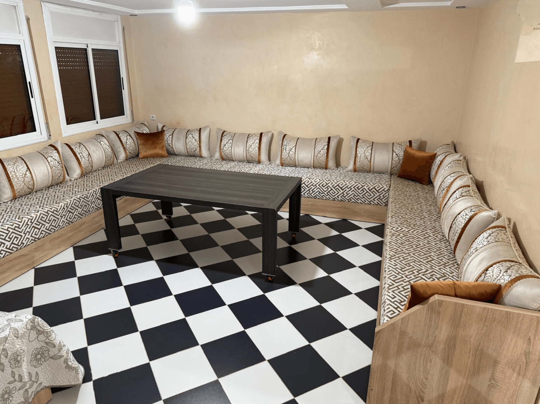 Living room with a traditional Moroccan salon and tiled floor