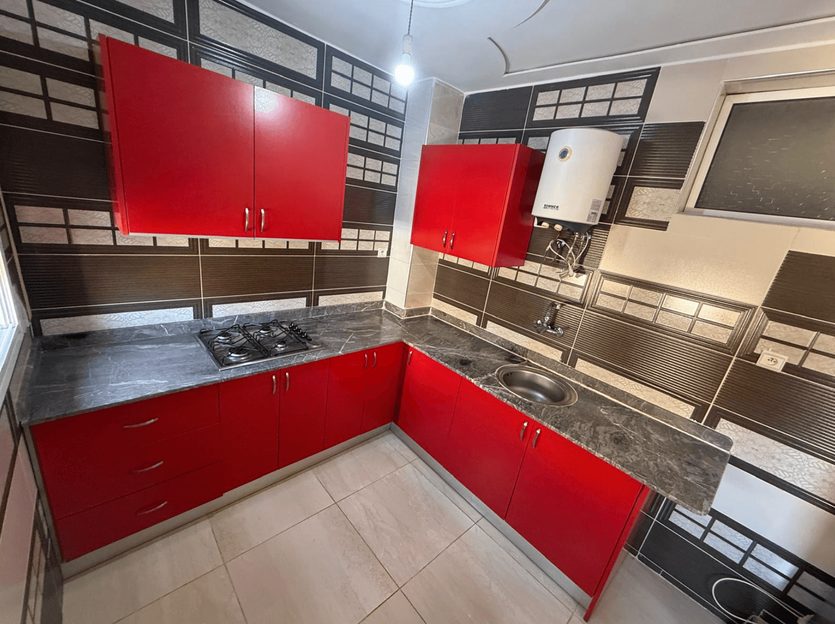 Fitted kitchen with red cabinets